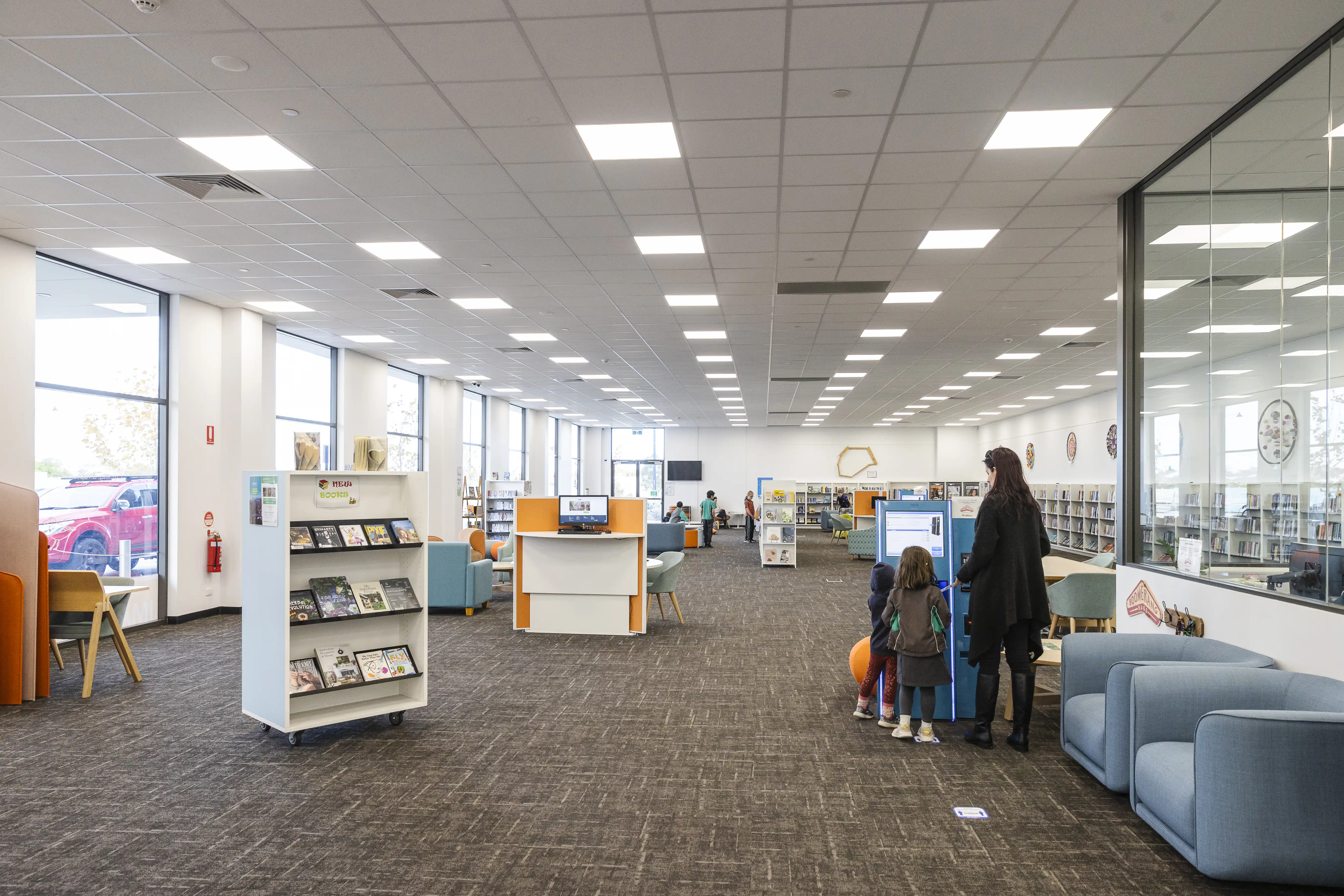 "people checking out books at the library"